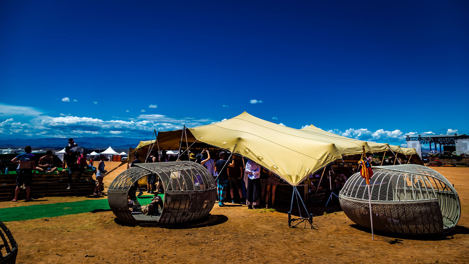 A lounge structure under a stretch tent at golden hour