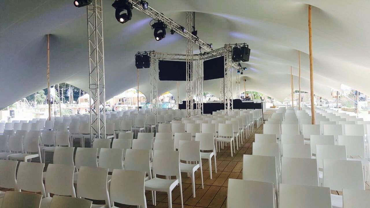 Rows of chairs set for a conference inside a stretch tent