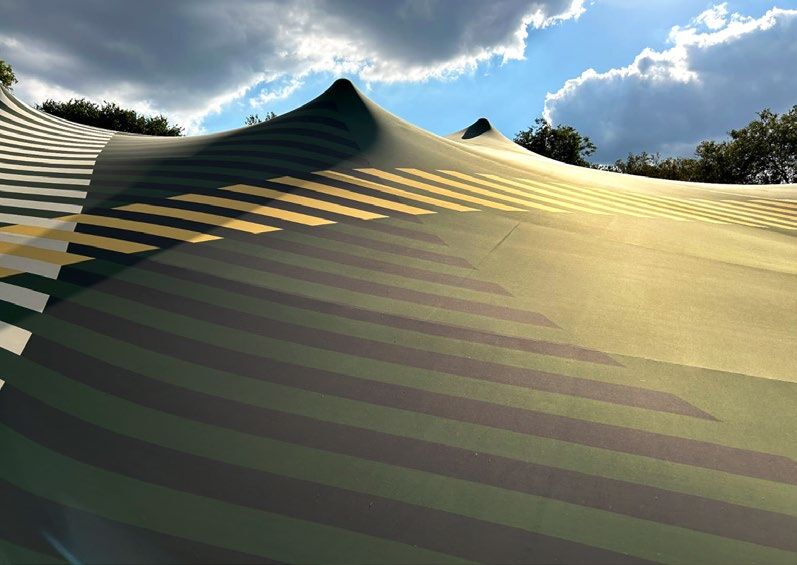 A striped lining fitted over the top of a stretch tent
