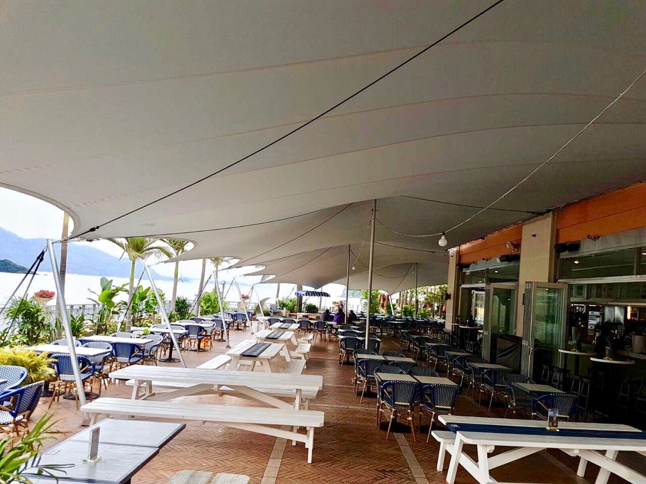 A restaurant terrace covered by a stretch canopy